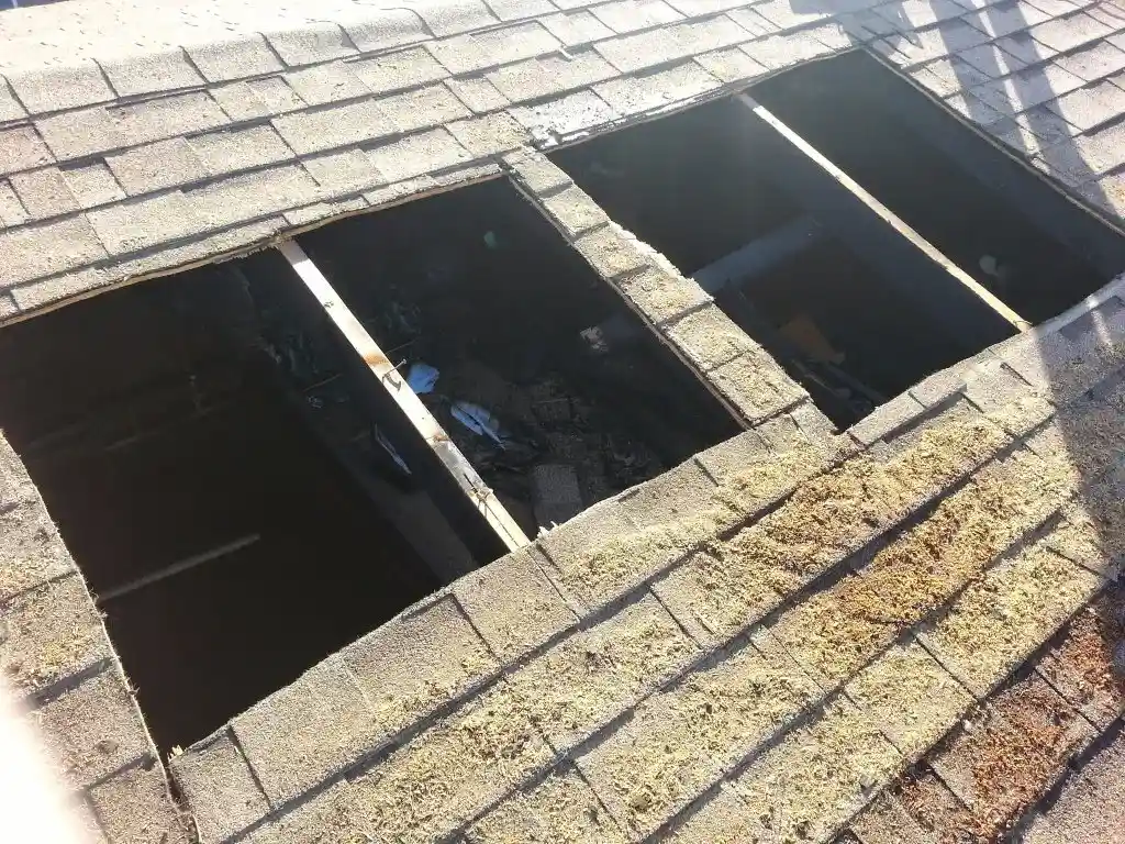 Roof hole from fire damage requiring tarping and board-up in Hesperia