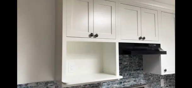 Valle Vista kitchen remodel photo from PL Builders showing finished white cabinet, tile backsplash, countertop, sink, and appliance layout