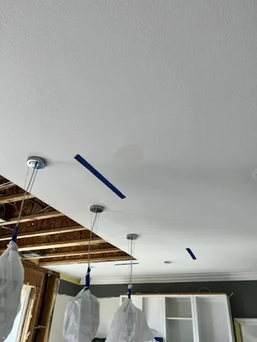 Ceiling and kitchen mitigation: San Jacinto burst pipe water damage restoration with mitigation, packout, custom cabinet reconstruction, real Carrara marble counters, and white oak herringbone flooring