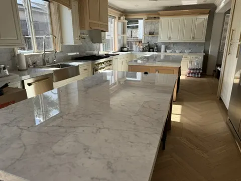 San Jacinto burst pipe water damage restoration with mitigation, packout, custom cabinet reconstruction, real Carrara marble counters, and white oak herringbone flooring