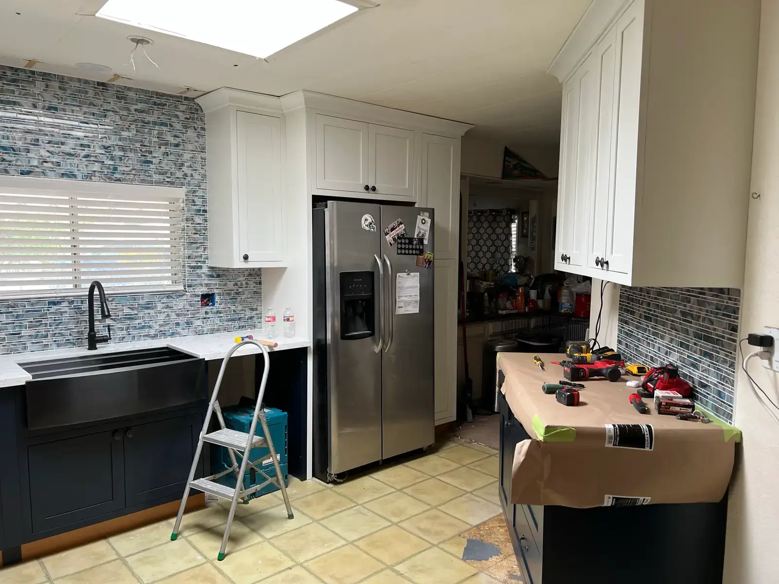 Valle Vista repeat-customer kitchen remodel near Hemet with white inset shaker cabinets, dark blue inset base cabinets, counters, cabinet hardware, flooring, trim, and finish details