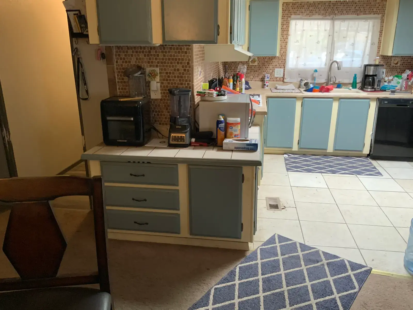 Before kitchen remodel: Valle Vista repeat-customer kitchen remodel near Hemet with white inset shaker cabinets, dark blue inset base cabinets, counters, cabinet hardware, flooring, trim, and finish details